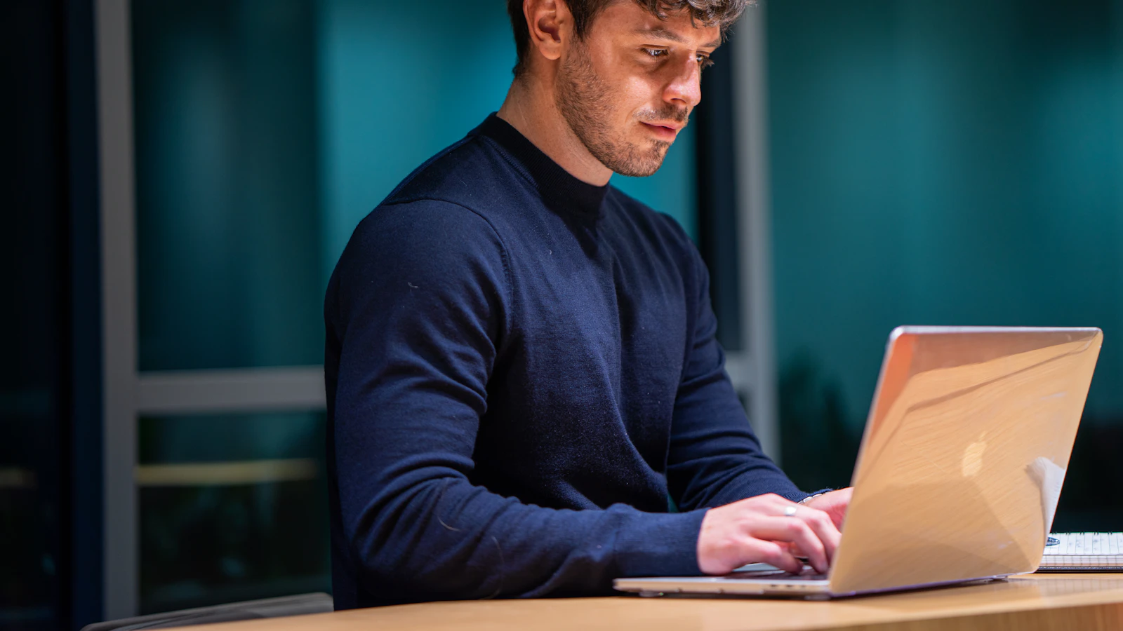 A professional working at a laptop.