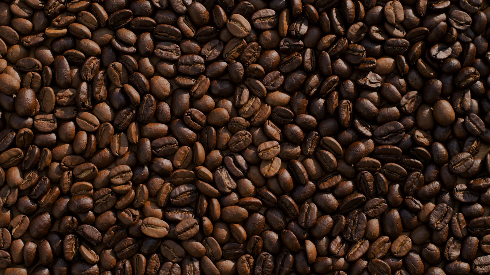 A cup of black coffee next to a paper filter on a counter, as an image for coffee and blood values.