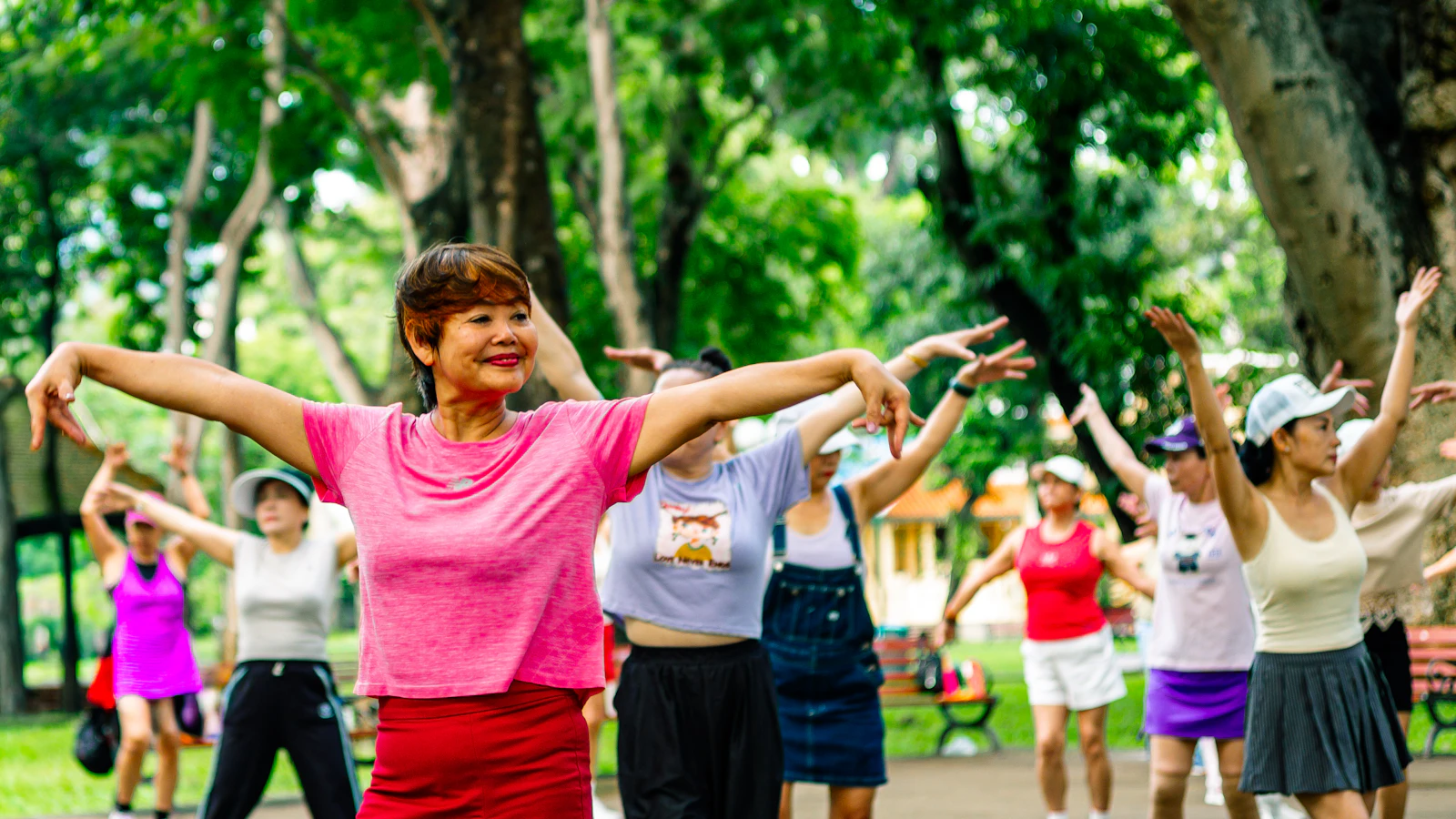 A group of women exercising together in a park.