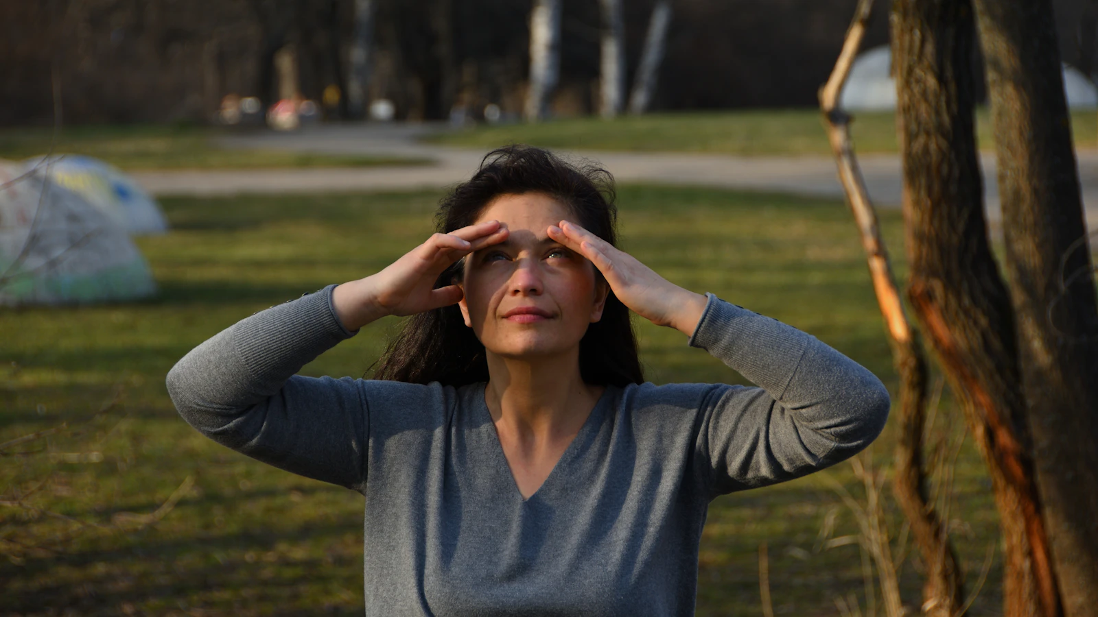 Vrouw wrijft vermoeid in haar ogen, als beeld bij vermoeidheid in de overgang.