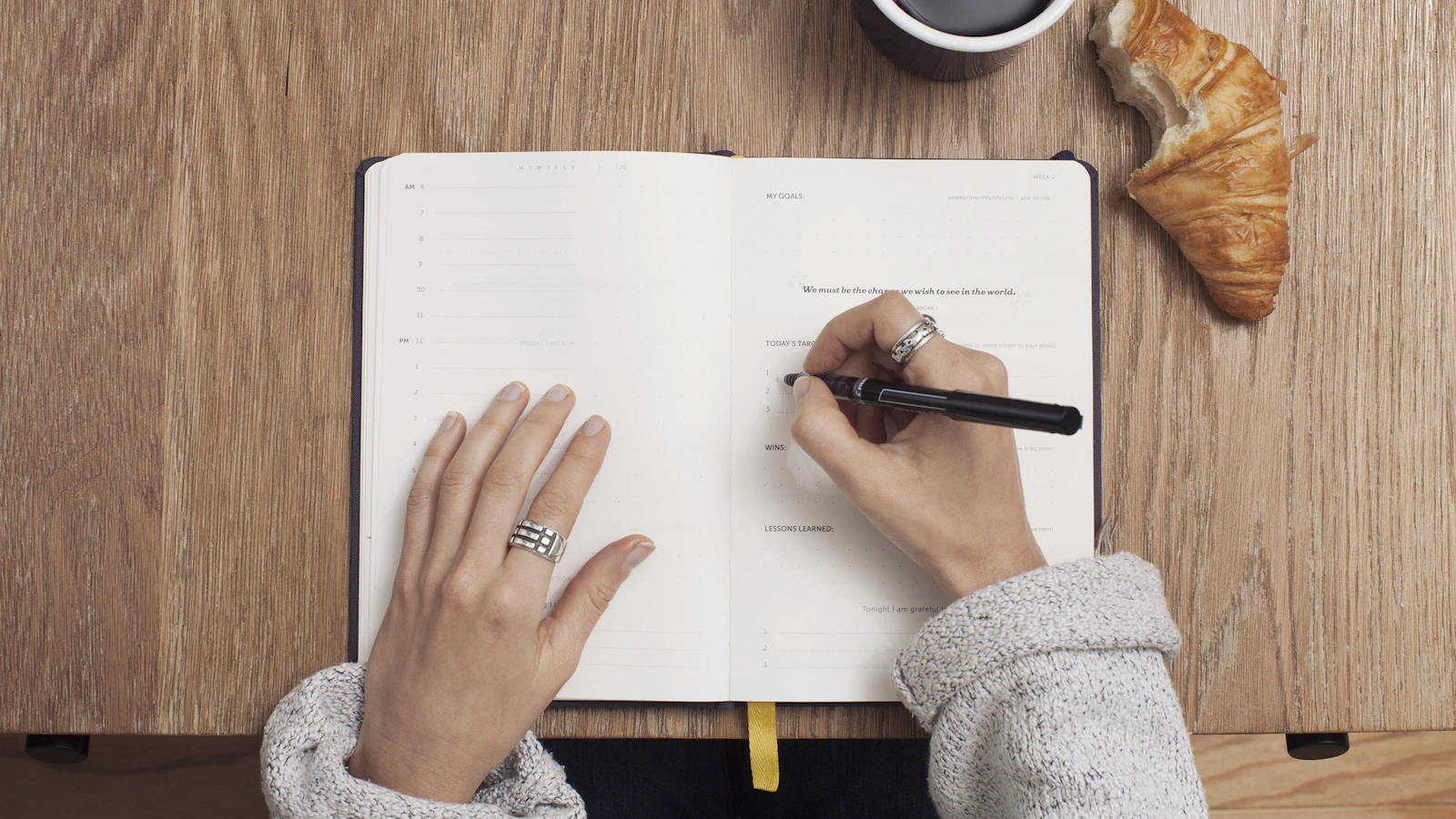 Woman noting something in a planner, illustrating tracking perimenopause symptoms.