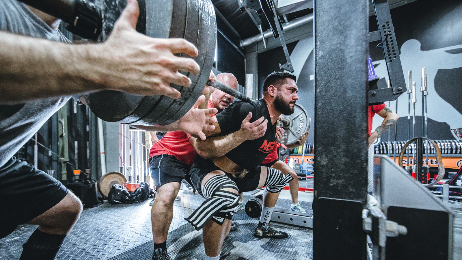 A man trains with weights in the gym.