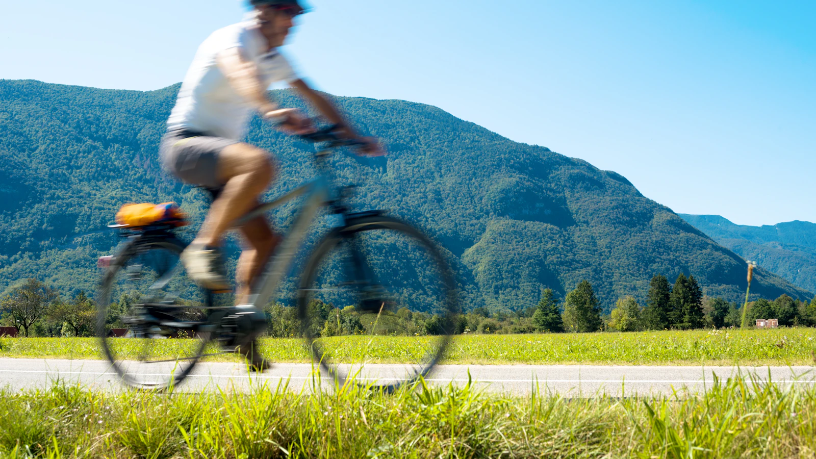 A man cycling outdoors on a mountain bike.