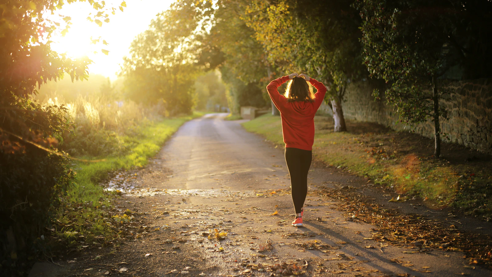 A woman walking on a path outdoors.